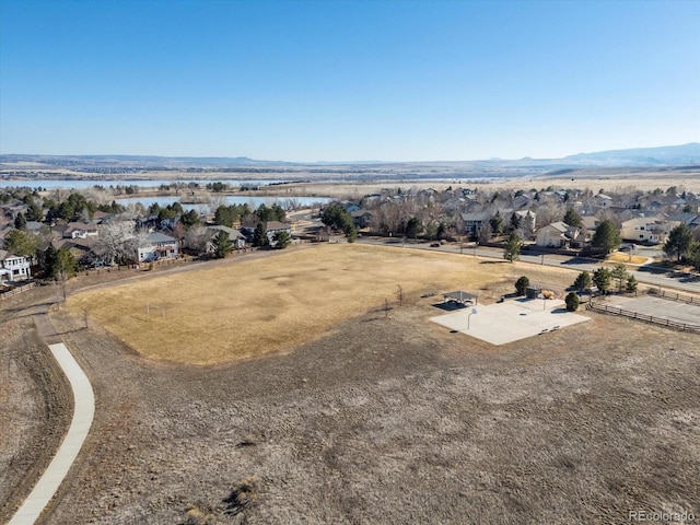 drone / aerial view with a water and mountain view