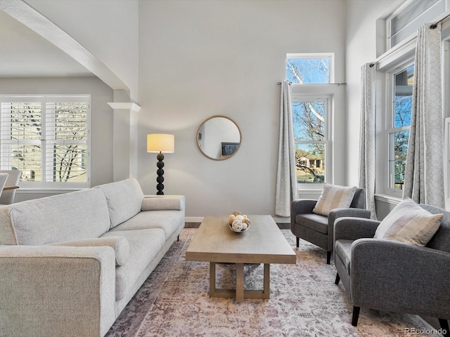 living room featuring a towering ceiling