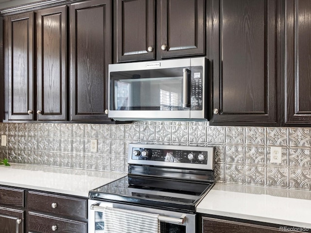 kitchen featuring tasteful backsplash, dark brown cabinetry, and appliances with stainless steel finishes