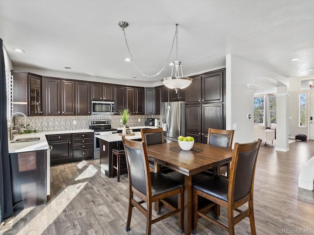 dining area featuring sink and light hardwood / wood-style flooring