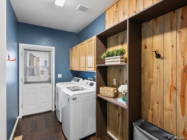 laundry area with cabinets, washing machine and dryer, and dark hardwood / wood-style floors