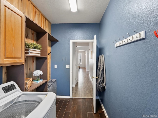 laundry room with washer / clothes dryer, a textured ceiling, and cabinets