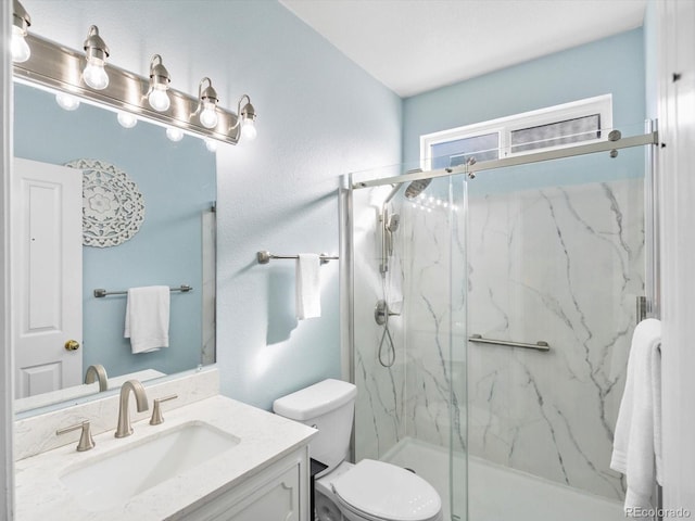 bathroom featuring walk in shower, vanity, and toilet