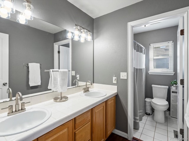 bathroom with vanity, tile patterned flooring, and toilet