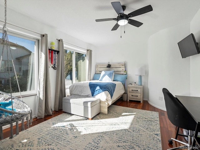 bedroom with ceiling fan and dark hardwood / wood-style flooring