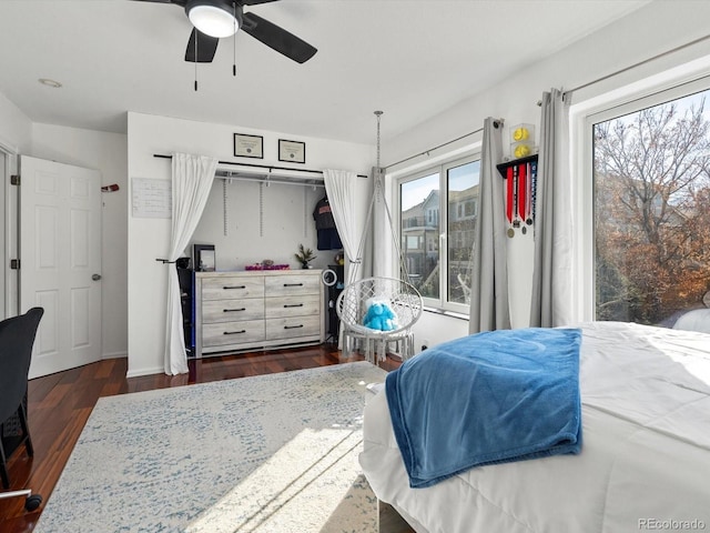 bedroom with dark hardwood / wood-style floors and ceiling fan