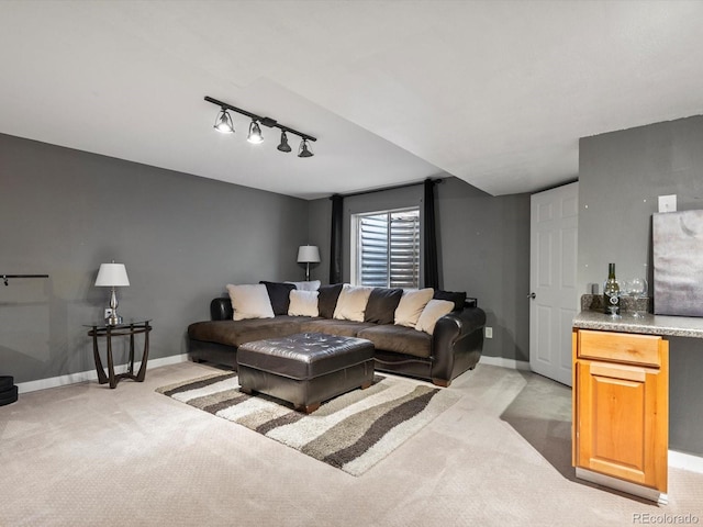 living room featuring light colored carpet and rail lighting