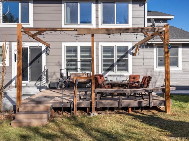 back of house featuring a lawn and a deck