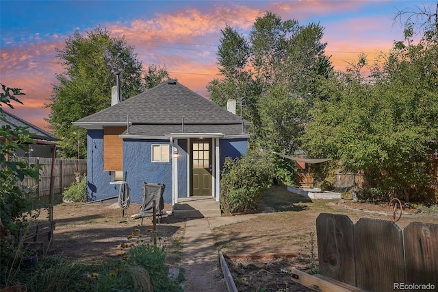 view of back house at dusk