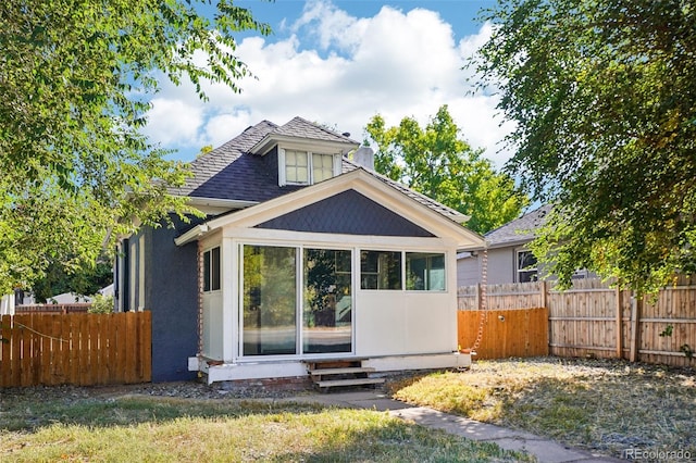 rear view of house with a yard