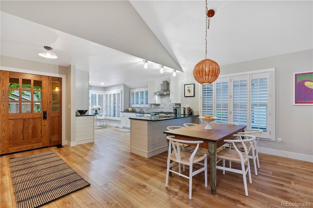 13 Pinyon Pine Rd, Littleton, CO 80127 - dining room with light wood-type flooring, baseboards, and lofted ceiling