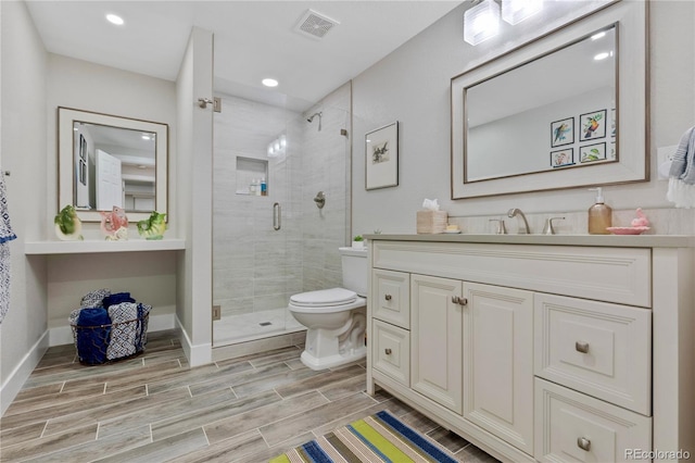 13 Pinyon Pine Rd, Littleton, CO 80127 - bathroom featuring a shower stall, vanity, toilet, wood finish floors, and recessed lighting