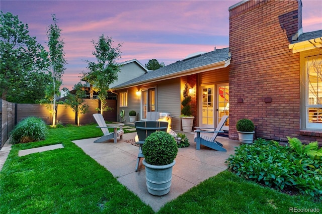 13 Pinyon Pine Rd, Littleton, CO 80127 - patio terrace at dusk featuring a patio area and an outdoor fire pit