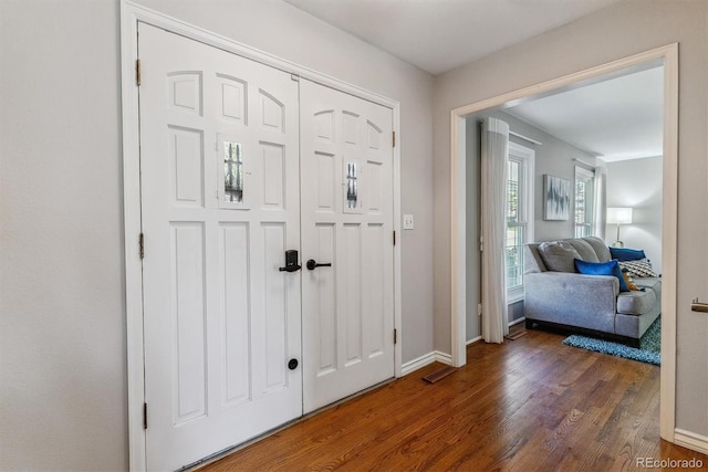 entryway featuring wood finished floors and baseboards