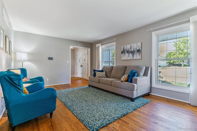 living area featuring baseboards and wood finished floors