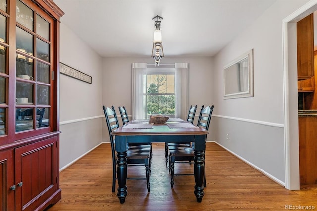 dining area with wood finished floors and baseboards