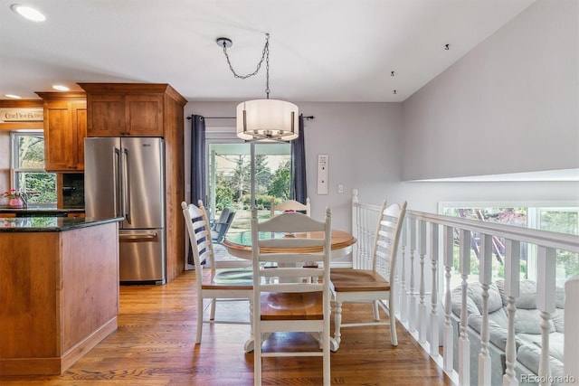 dining room with healthy amount of natural light, a chandelier, light wood finished floors, recessed lighting, and baseboards