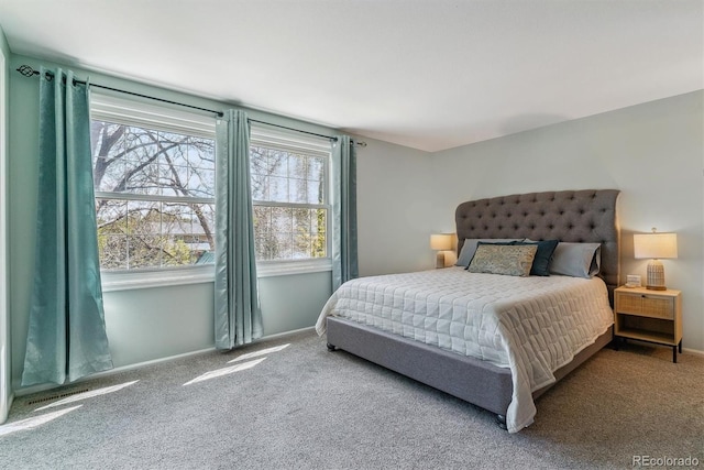 bedroom with carpet flooring and baseboards