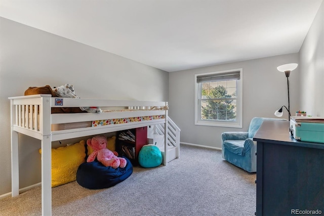 carpeted bedroom featuring baseboards