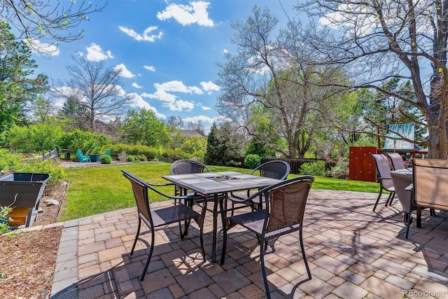 view of patio featuring outdoor dining space and a playground