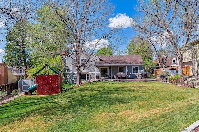 back of house featuring a shed, an outbuilding, and a patio