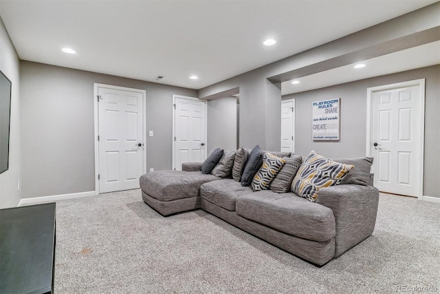 carpeted living area with recessed lighting and baseboards