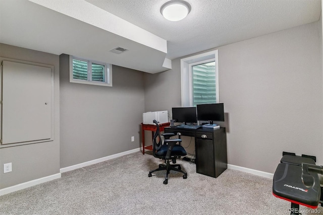 office area with a textured ceiling, carpet, and baseboards