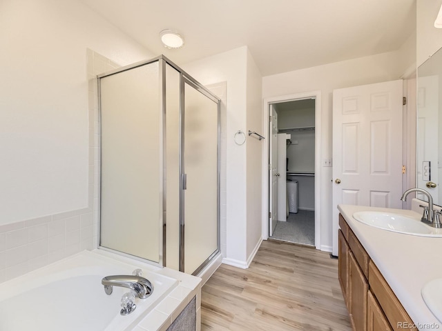 bathroom featuring vanity, independent shower and bath, and wood-type flooring