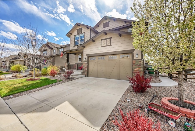 craftsman-style home with driveway and stone siding