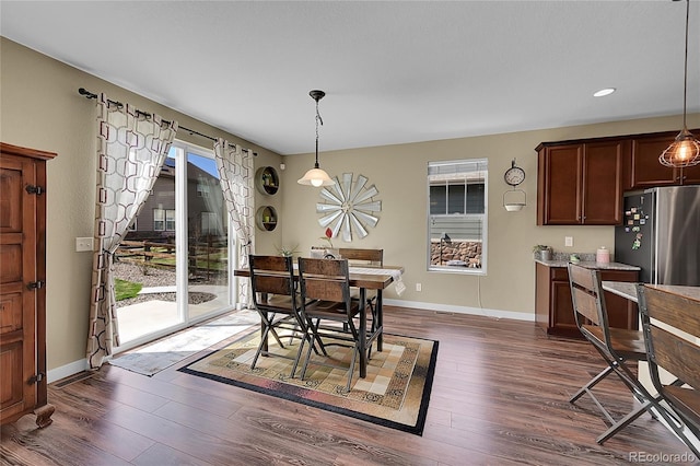 dining room featuring plenty of natural light, baseboards, recessed lighting, and dark wood finished floors
