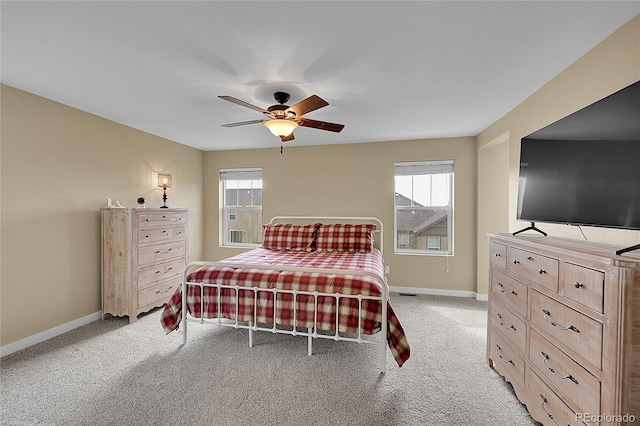 bedroom featuring ceiling fan, light carpet, and baseboards