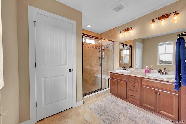 full bath featuring visible vents, a shower stall, a healthy amount of sunlight, and a sink