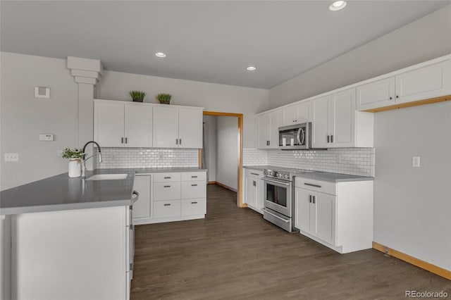 6696 Sunset Cir, Kiowa, CO 80117 - kitchen featuring appliances with stainless steel finishes, a sink, white cabinets, decorative backsplash, and recessed lighting