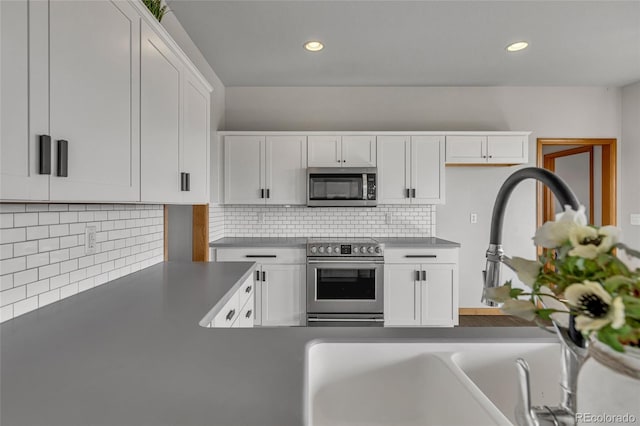 6696 Sunset Cir, Kiowa, CO 80117 - kitchen with stainless steel appliances, white cabinets, decorative backsplash, recessed lighting, and a sink