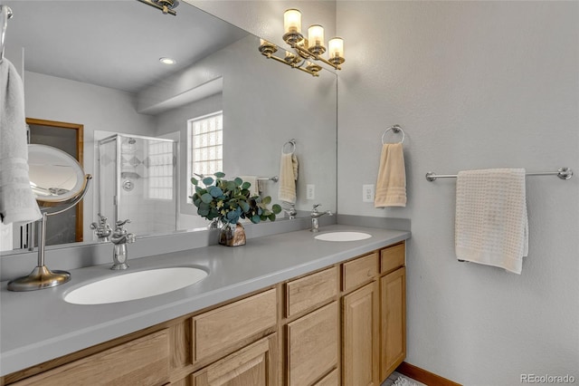 bathroom featuring vanity and a shower with door