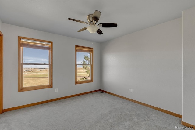 unfurnished room featuring ceiling fan and light colored carpet