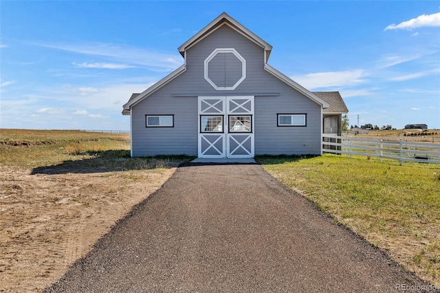 view of outbuilding with a yard and a rural view