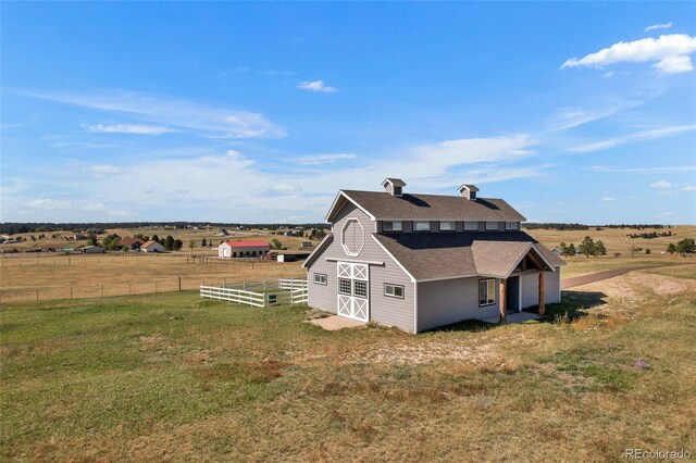 6696 Sunset Cir, Kiowa, CO 80117 - view of side of property featuring a barn, an outbuilding, a shingled roof, and a rural view