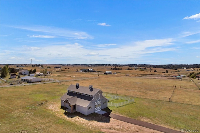 birds eye view of property with a rural view