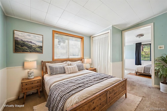 5818 S Skyline Dr, Evergreen, CO 80439 - bedroom featuring multiple windows, a wainscoted wall, lofted ceiling, and carpet floors