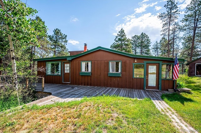 5818 S Skyline Dr, Evergreen, CO 80439 - back of house featuring a lawn, a deck, and board and batten siding