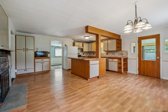 5818 S Skyline Dr, Evergreen, CO 80439 - kitchen with black microwave, freestanding refrigerator, a chandelier, light wood finished floors, and decorative backsplash