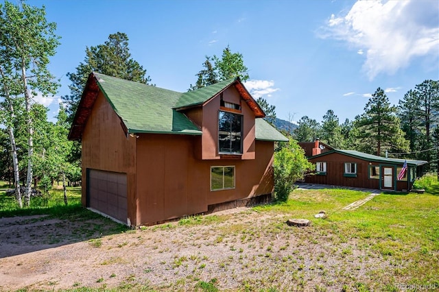 5818 S Skyline Dr, Evergreen, CO 80439 - view of home's exterior with a garage and a lawn