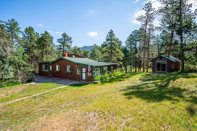 5818 S Skyline Dr, Evergreen, CO 80439 - view of green lawn with an outdoor structure and a wooden deck