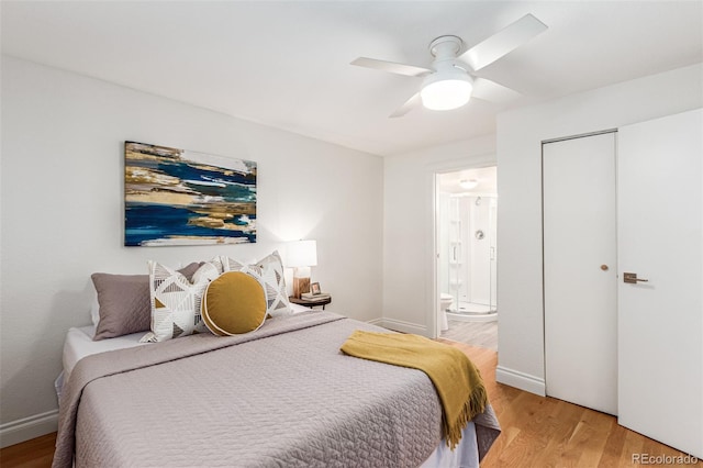 bedroom featuring ceiling fan, ensuite bathroom, and light hardwood / wood-style flooring