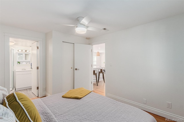 bedroom with ceiling fan, connected bathroom, a closet, and light hardwood / wood-style flooring