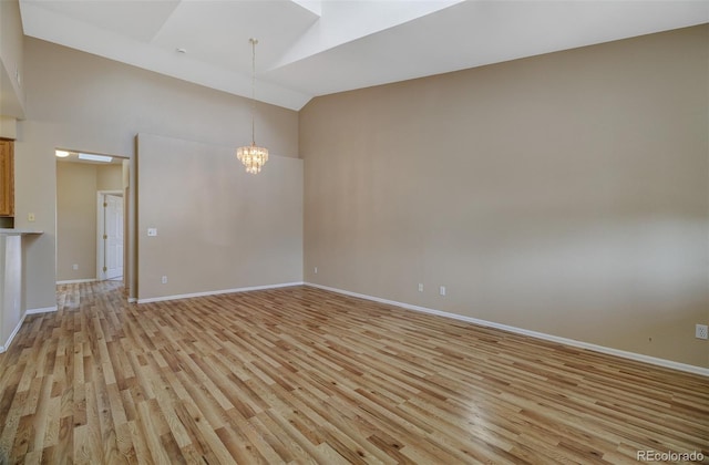 1343 Villa Grv, Monument, CO 80132 - spare room with light wood-style floors, a chandelier, baseboards, and high vaulted ceiling