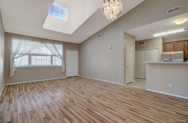1343 Villa Grv, Monument, CO 80132 - unfurnished living room featuring light wood-style floors, plenty of natural light, lofted ceiling, and baseboards