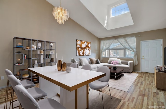 1343 Villa Grv, Monument, CO 80132 - dining space featuring high vaulted ceiling, a chandelier, light wood-style floors, and a skylight