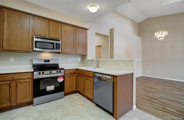1343 Villa Grv, Monument, CO 80132 - kitchen featuring stainless steel appliances, a sink, vaulted ceiling, brown cabinetry, and a chandelier